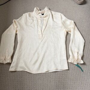 Nili Lotan cream silk ruffled blouse.